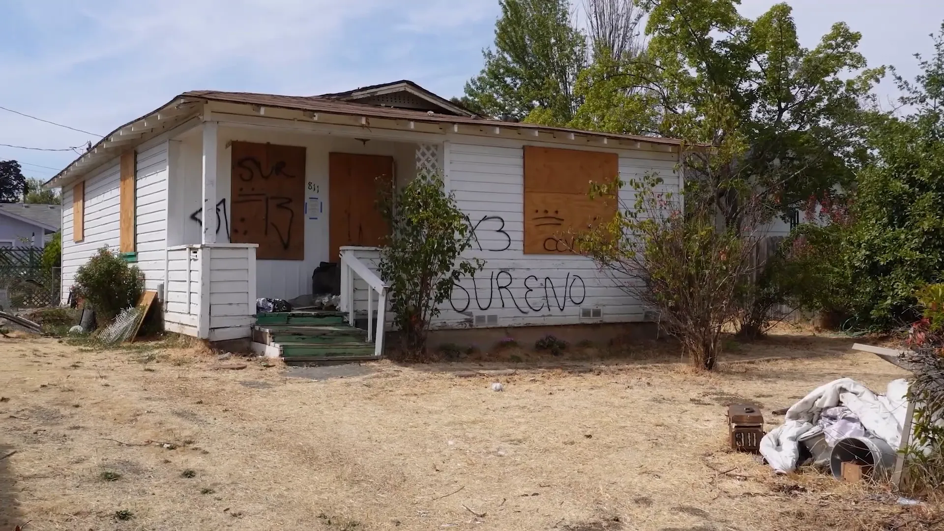 Downtown Medford showing boarded-up homes and graffiti