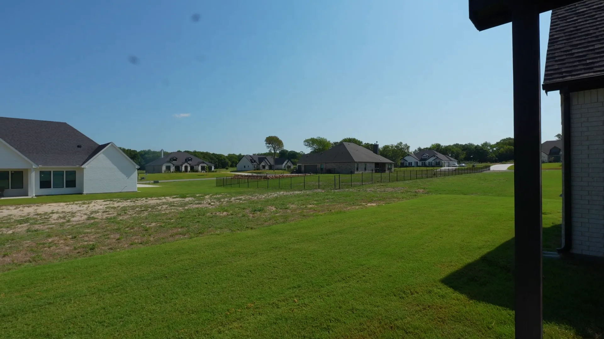 Property flag showing how far the one-acre lot extends behind the house