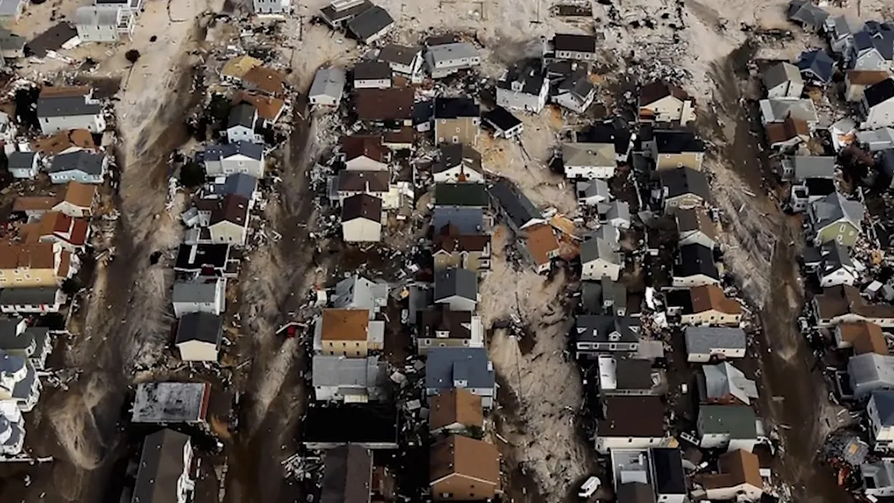 Close aerial view showing rows of shore houses with severe flood and storm damage