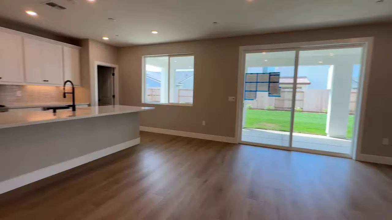 Spacious living area with sliding doors and modern finishes in Arbor Ranch Elk Grove home