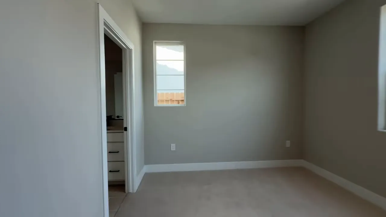 Empty bedroom with doorway and window in Arbor Ranch Elk Grove Plan 5002 home