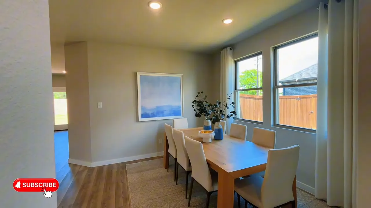 Dining area with rectangular table, six chairs, and two windows