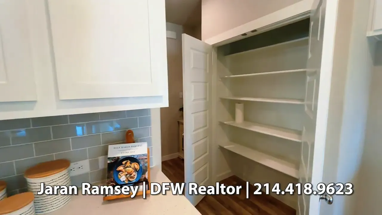 Kitchen pantry with open shelves next to white cabinetry