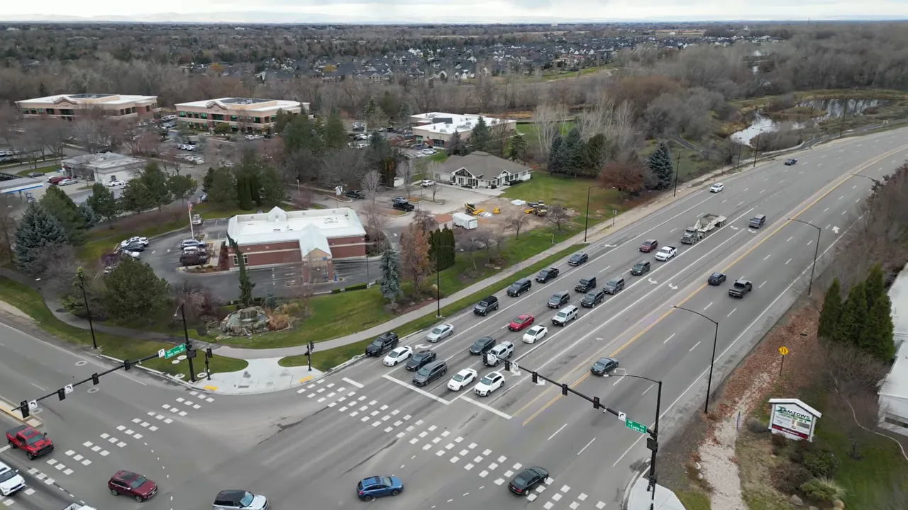 Aerial view of a busy multilane intersection with lines of cars