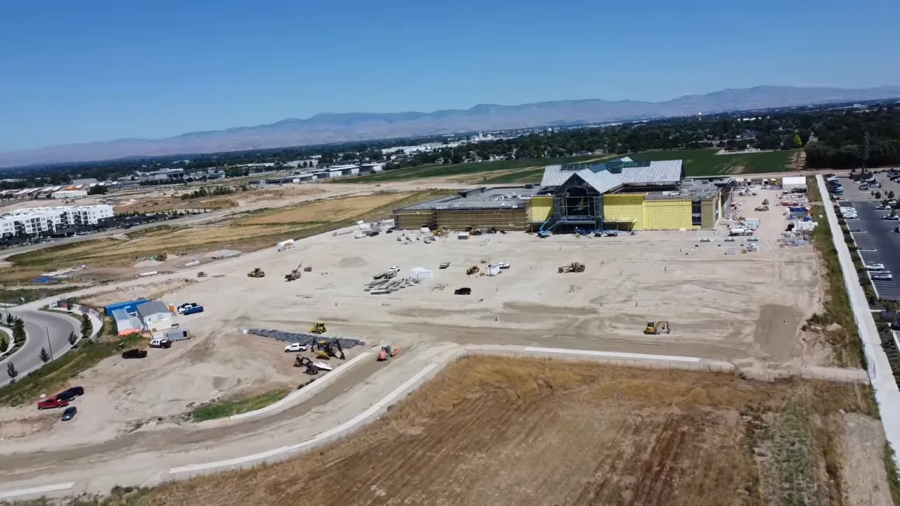 Aerial view of a large construction site with roads equipment and a building in progress