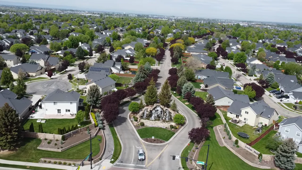 Aerial view of a landscaped residential neighborhood with large homes
