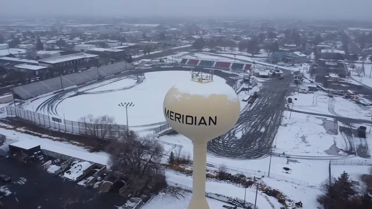Snowy aerial view of the Meridian water tower and surrounding city