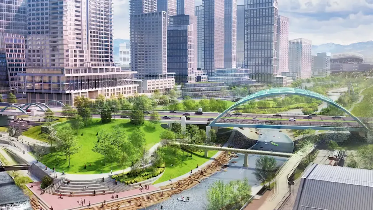 Rendering of green riverfront park and bridge surrounded by downtown towers