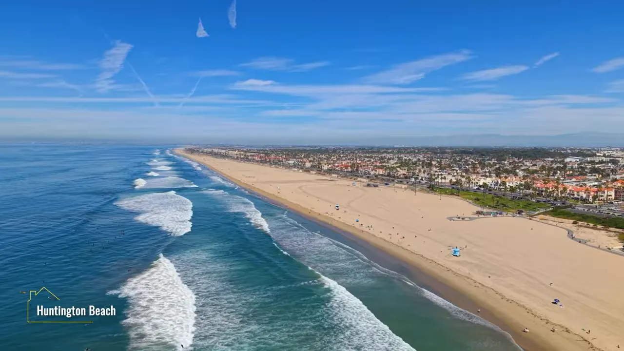 Aerial view of wide Huntington Beach shoreline and ocean waves
