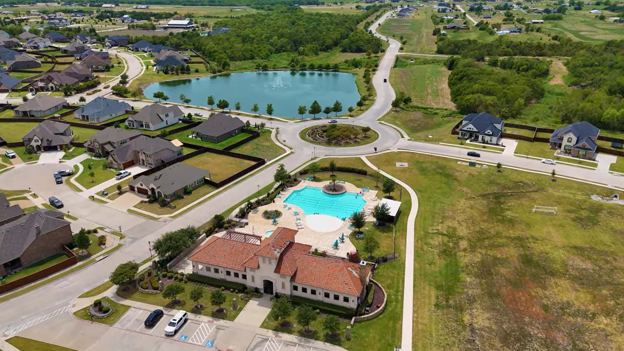 Aerial view of Sonoma Verde amenities pool and sports courts with open surrounding land