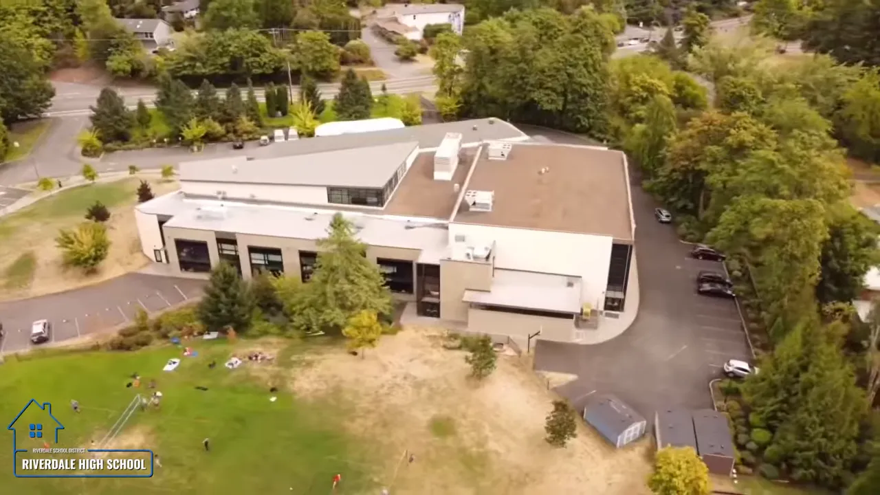 Aerial view of Riverdale High School campus with fields and parking