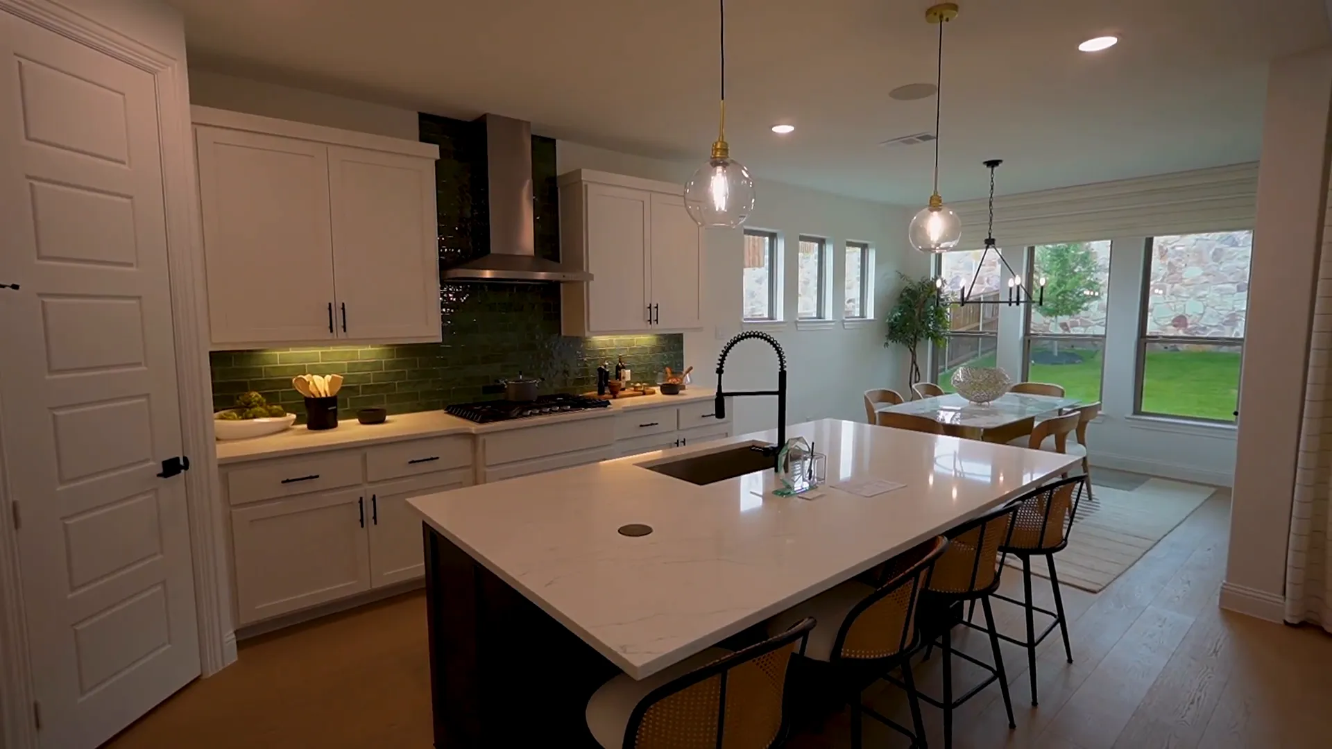 Kitchen with large island, two-tone cabinetry, and built-in appliances