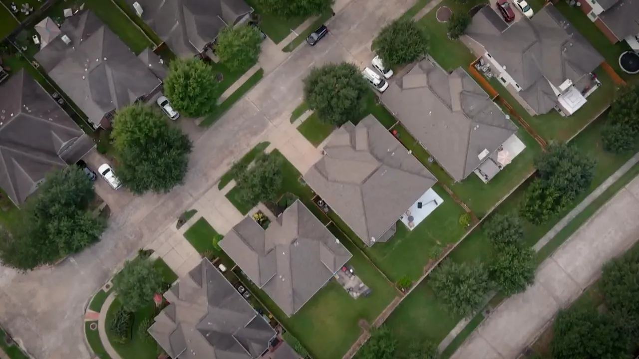 Aerial view of multiple homes and lots in a residential neighborhood