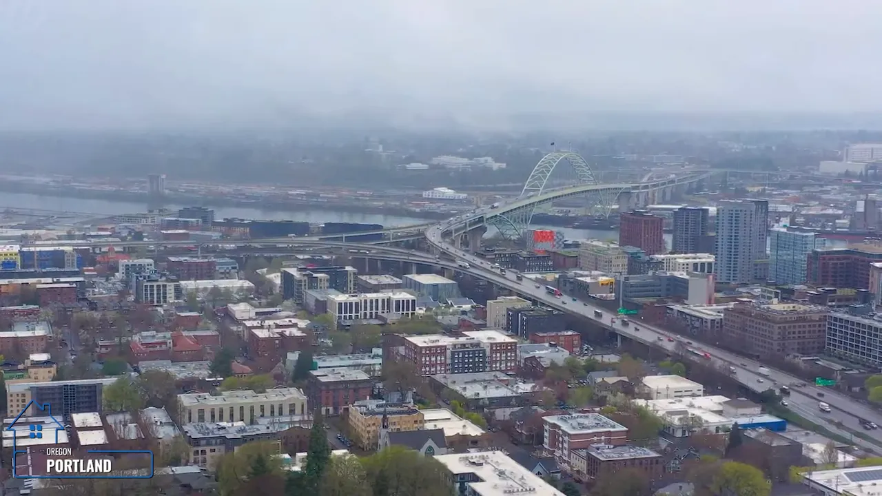 Foggy aerial view of Portland skyline under gray low clouds