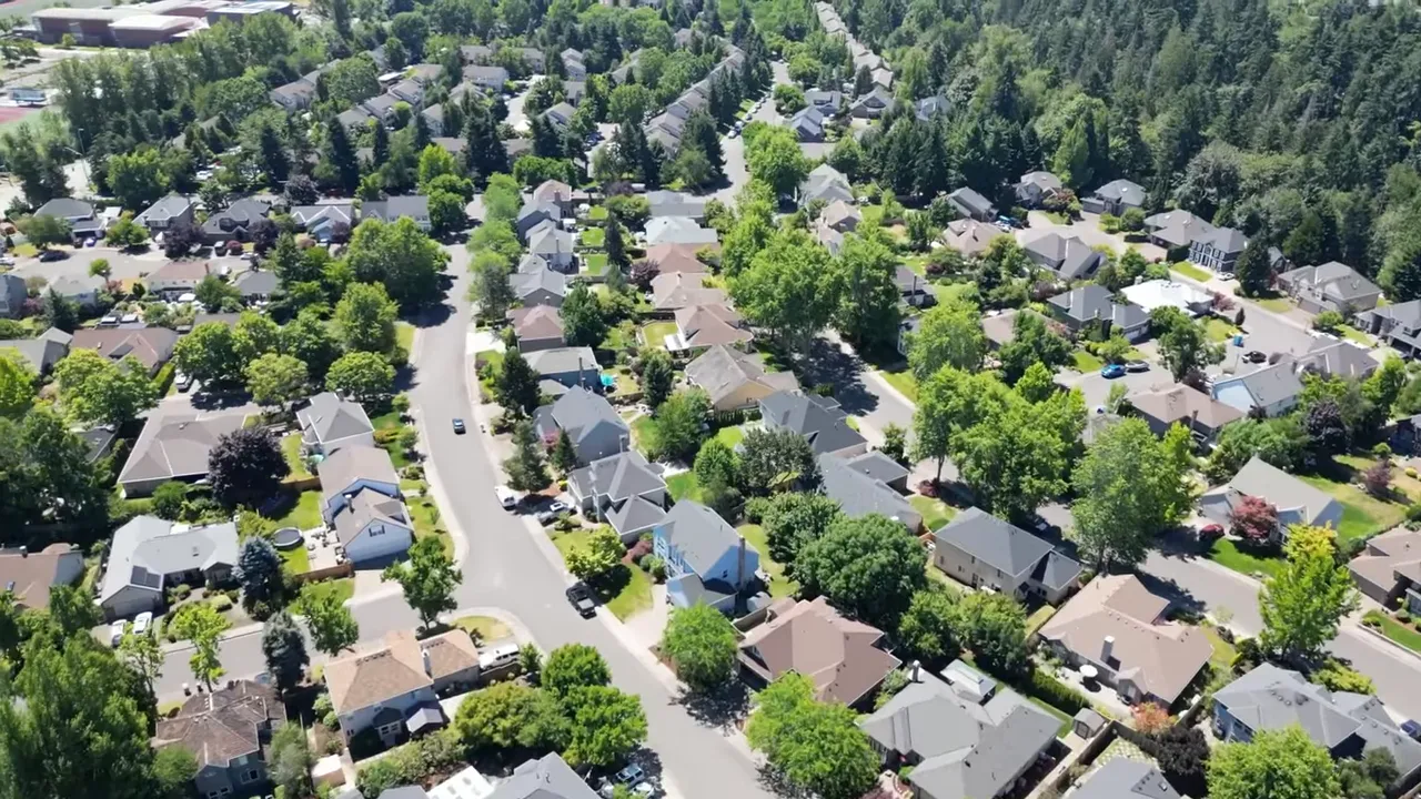 Aerial view of a leafy suburban neighborhood with winding streets and homes