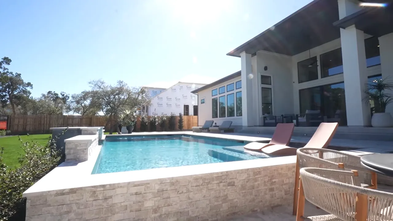 Backyard pool and covered patio outdoor living area in Caliterra, Dripping Springs Texas