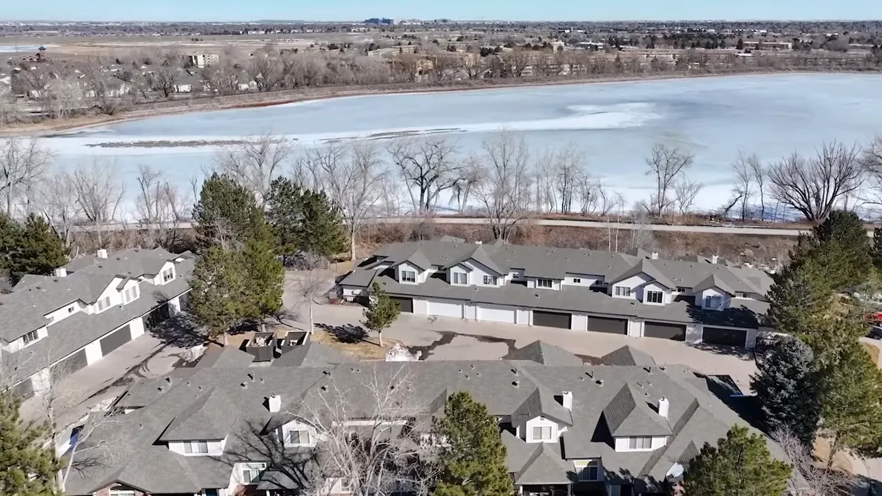 Aerial view of a Denver area master-planned community with many homes and winter landscape
