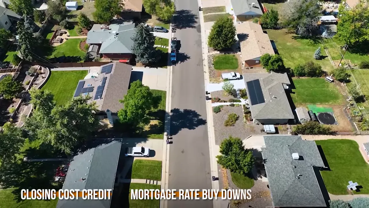 Aerial view of homes with on-screen text about closing cost credit and mortgage rate buy-downs