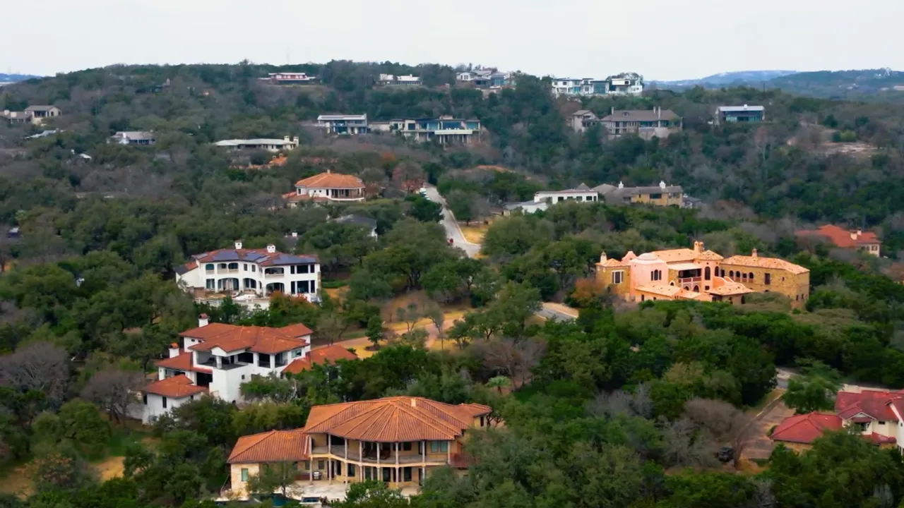 Aerial photo of luxury hillside homes and trees in Westlake Hills, Austin