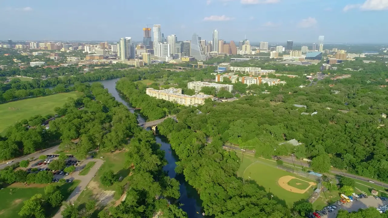 Aerial view of Austin skyline with river, parks and greenbelt