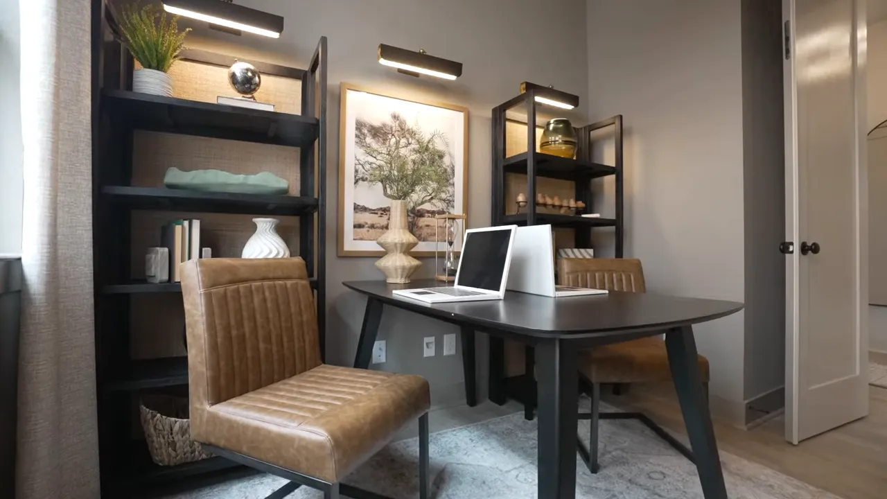 Enclosed study with desk bookshelves window and chair