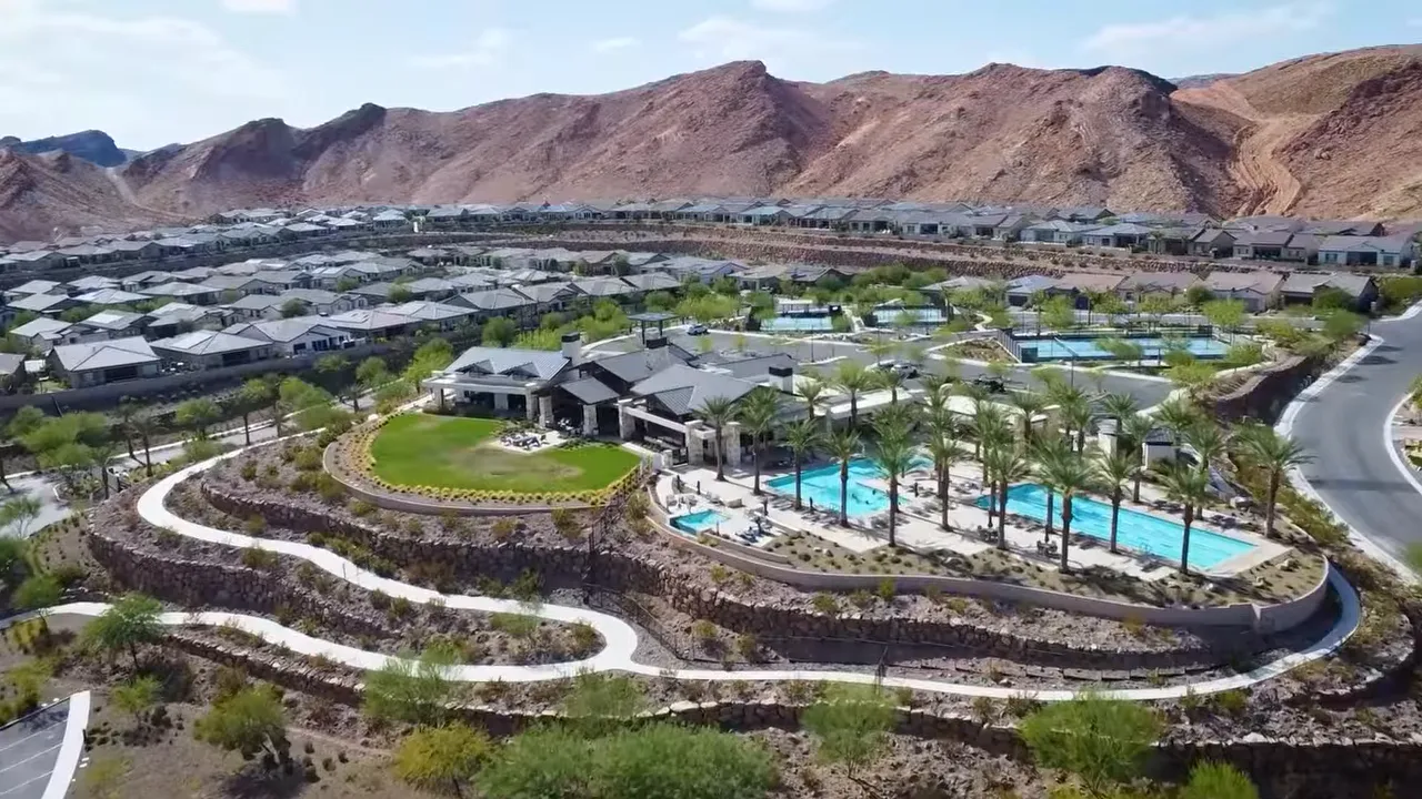 Aerial view of Trilogy Sunstone pool and clubhouse with mountain backdrop