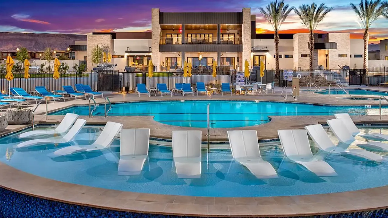 Resort style pool with lounge chairs at Trilogy Sunstone