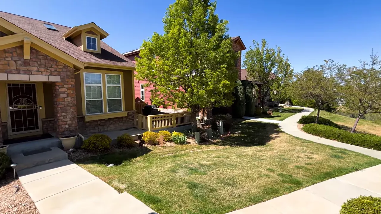 Patio-style home exterior with landscaped yard and walkways in the Denver metro