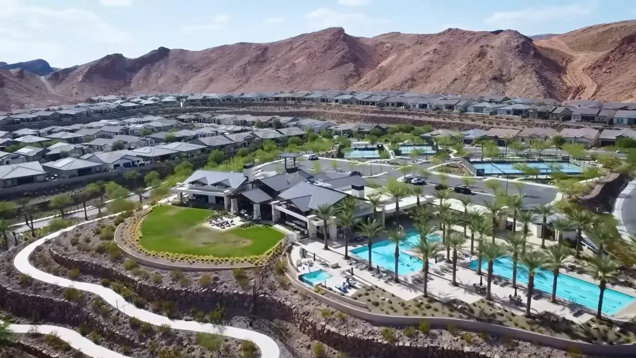 Aerial view of Del Webb amenities and pools beside mountain landscape