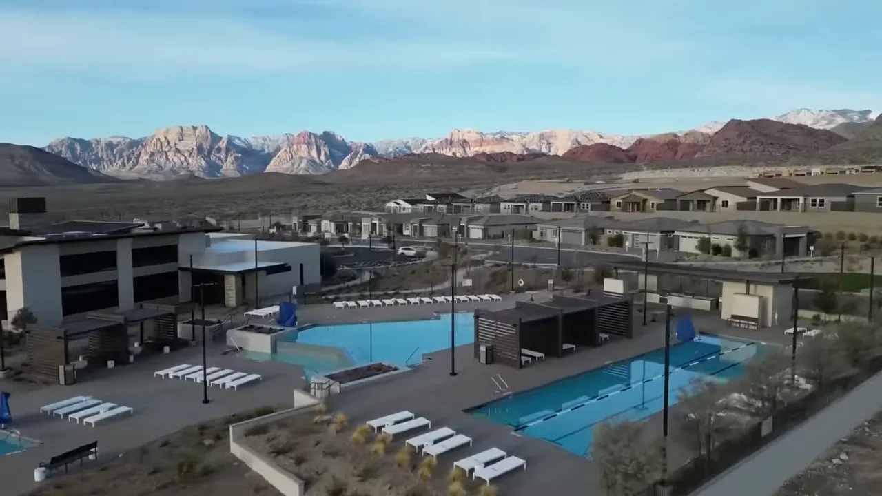 Heritage at Stonebridge clubhouse and blue swimming pools with mountain views