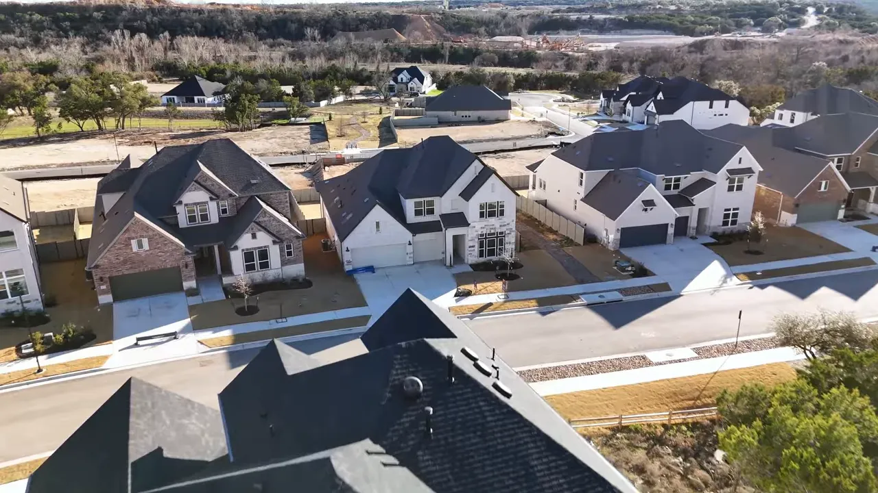 Aerial view of new homes in Wolf Ranch with surrounding hills and street layout