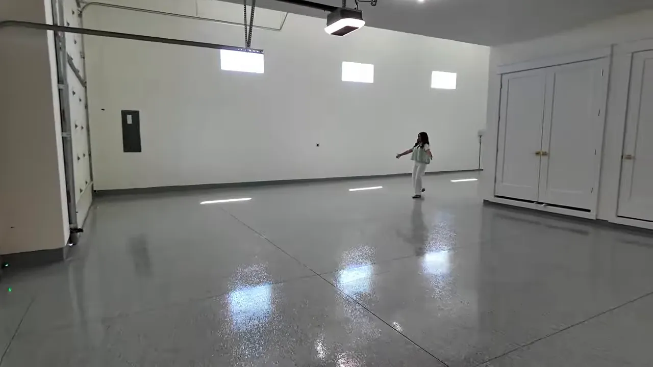 Long RV garage bay with polished epoxy floor and white walls