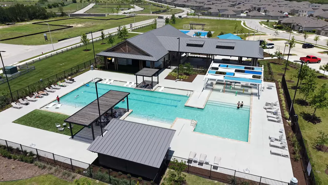 aerial view of amenity center with pool pavilion splash pad and surrounding paths