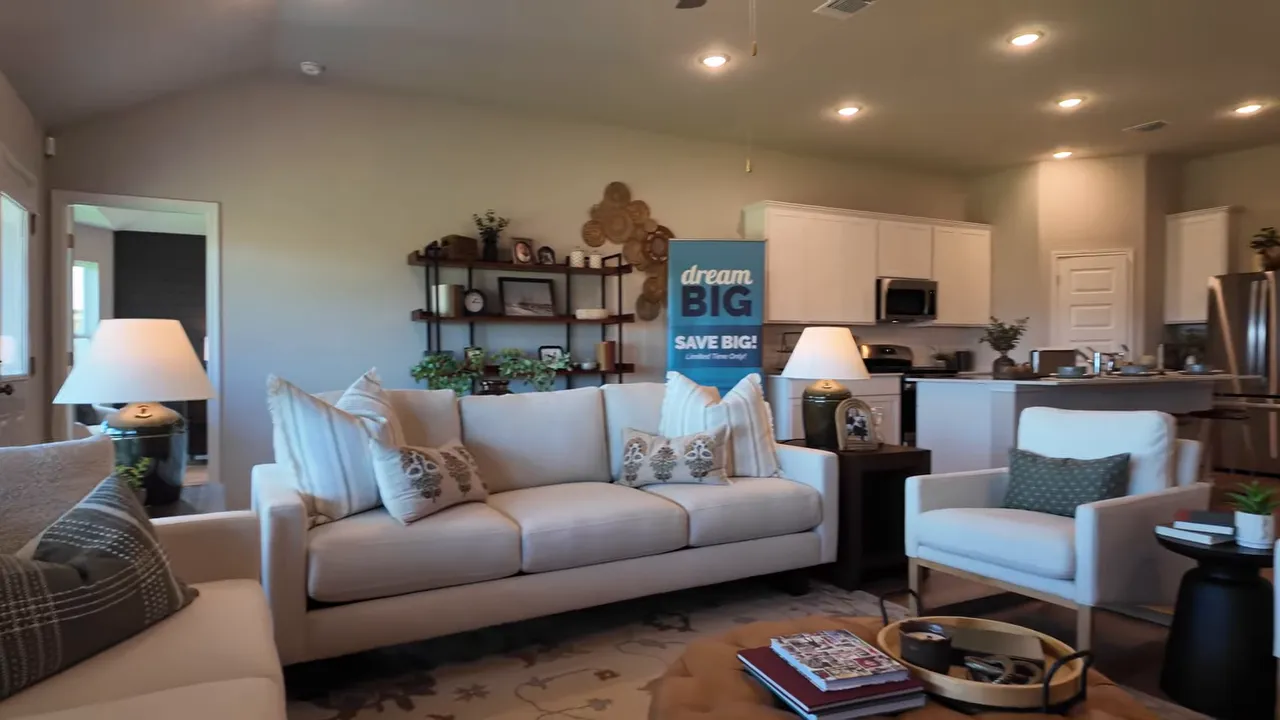 open living room kitchen and dining area with large windows and island