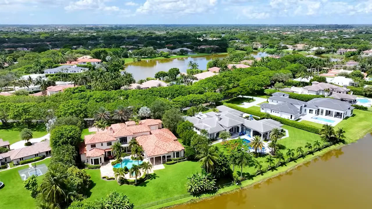 Aerial view of large homes separated by expansive green lots