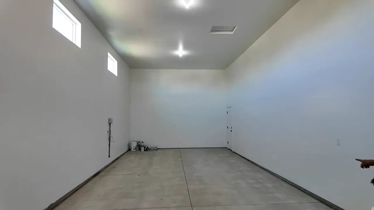 Wide interior view of a 44-foot deep RV bay with blank walls and concrete flooring