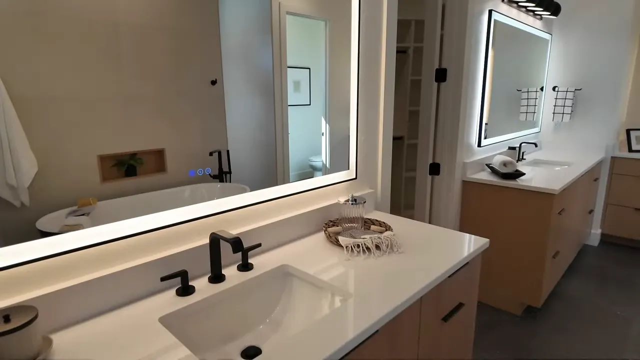 Illuminated anti-fog mirrors over the dual sinks in the primary bathroom