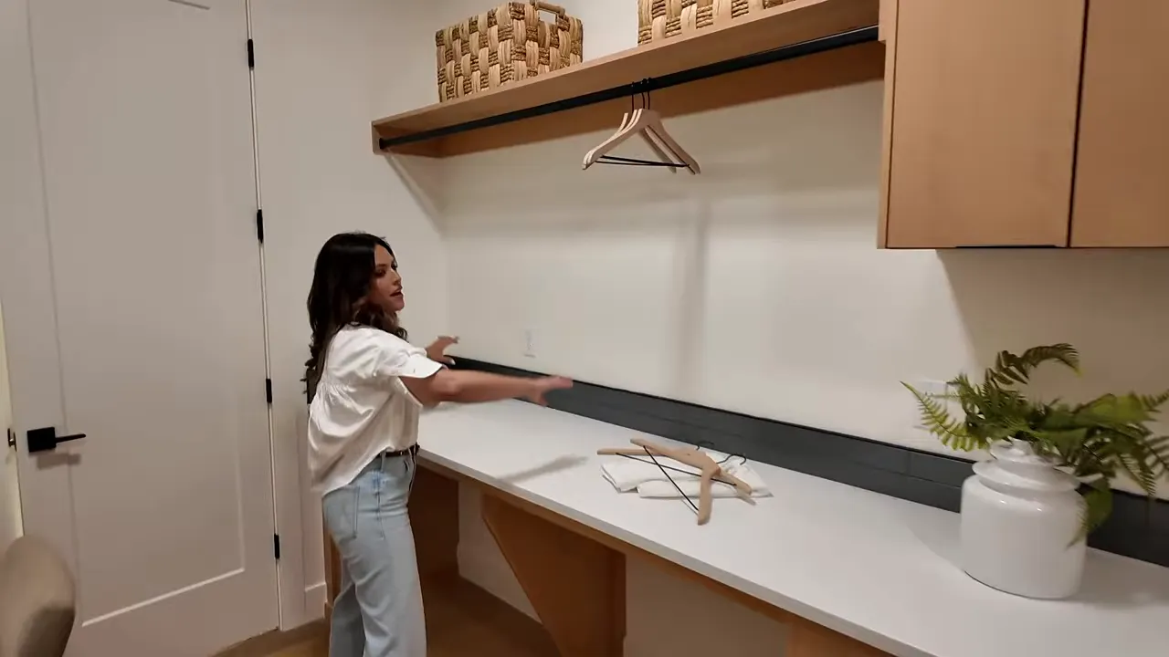 Laundry room folding counter area with cabinetry and storage shelf in a Boise home