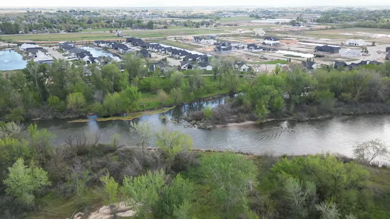 Aerial view of Boise River shoreline and a nearby waterfront community neighborhood