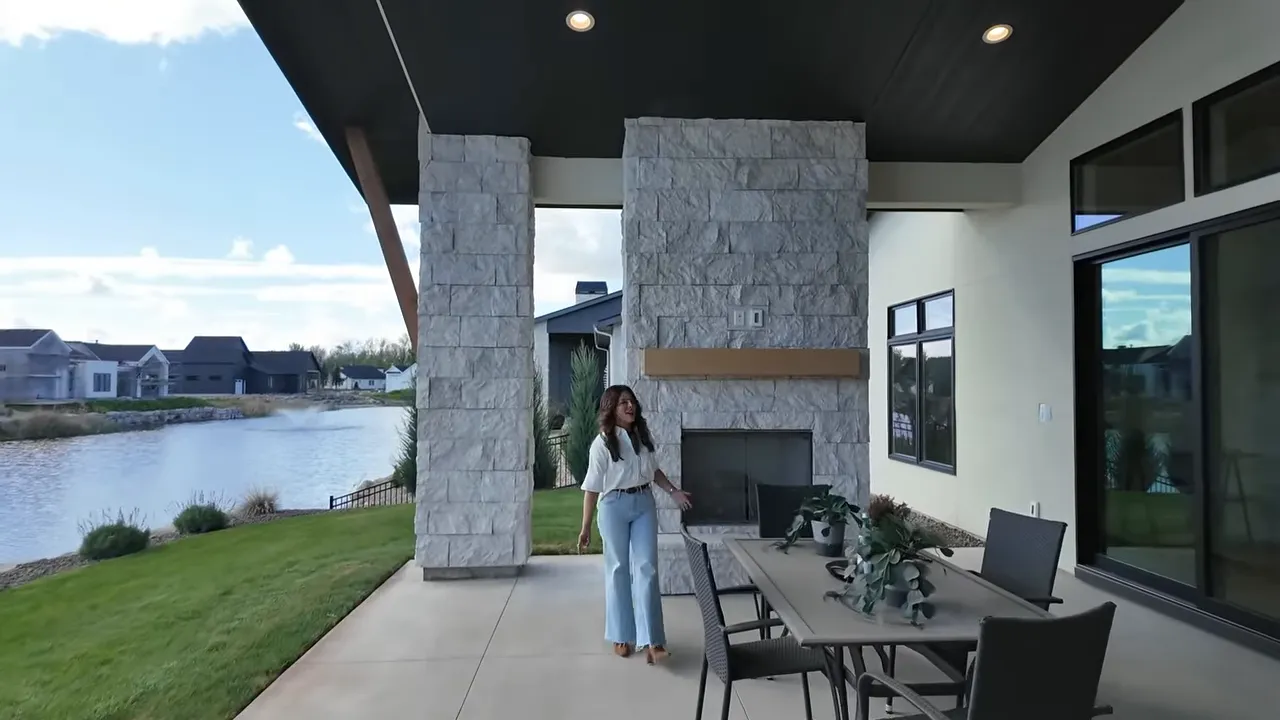 Covered patio with fireplace and pond views in a Boise waterfront home