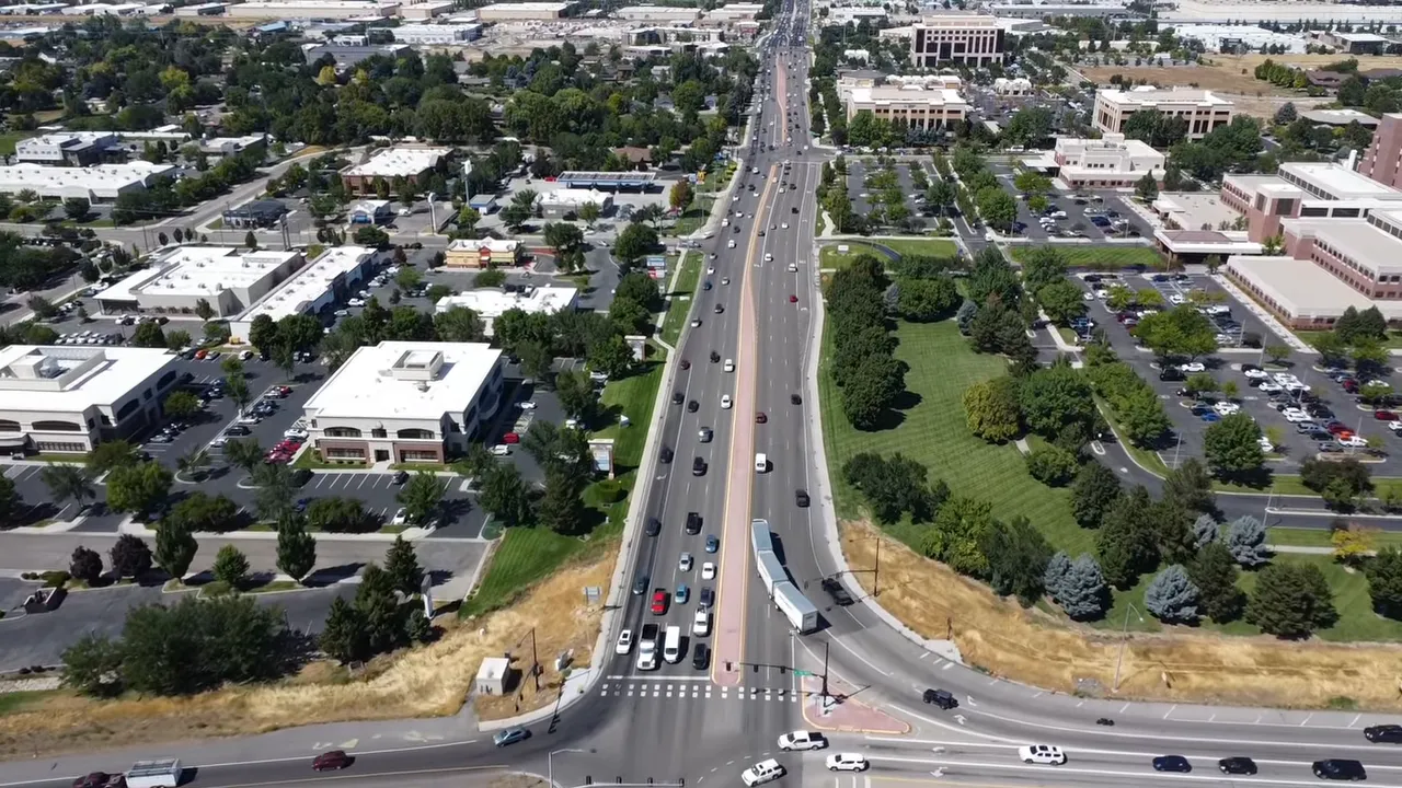 Aerial view looking down a busy multi-lane arterial in Eagle, Idaho with traffic toward the horizon