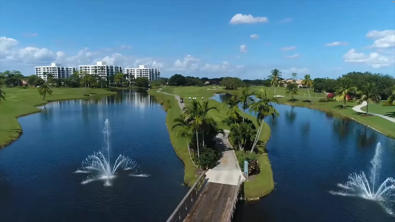 Aerial view showing lakes, fountain, bridge, and golf fairways at Boca West