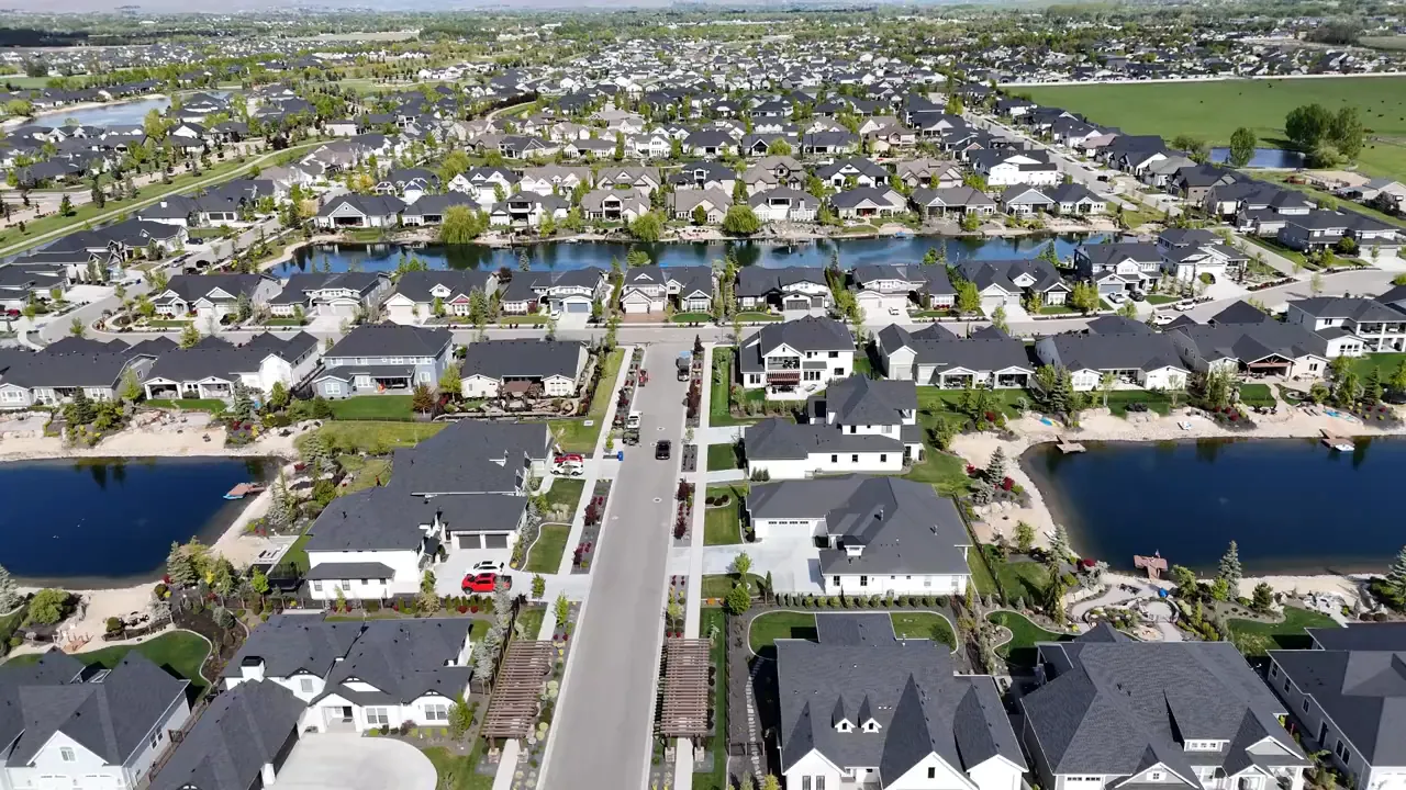 Aerial view of an Eagle Idaho neighborhood with homes and water