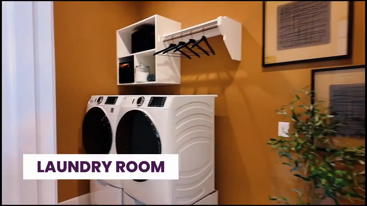 Laundry room with front load washer dryer upper cubbies and hanging rod