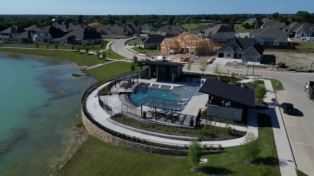 Aerial view of resort style community pool by the water in The Terraces