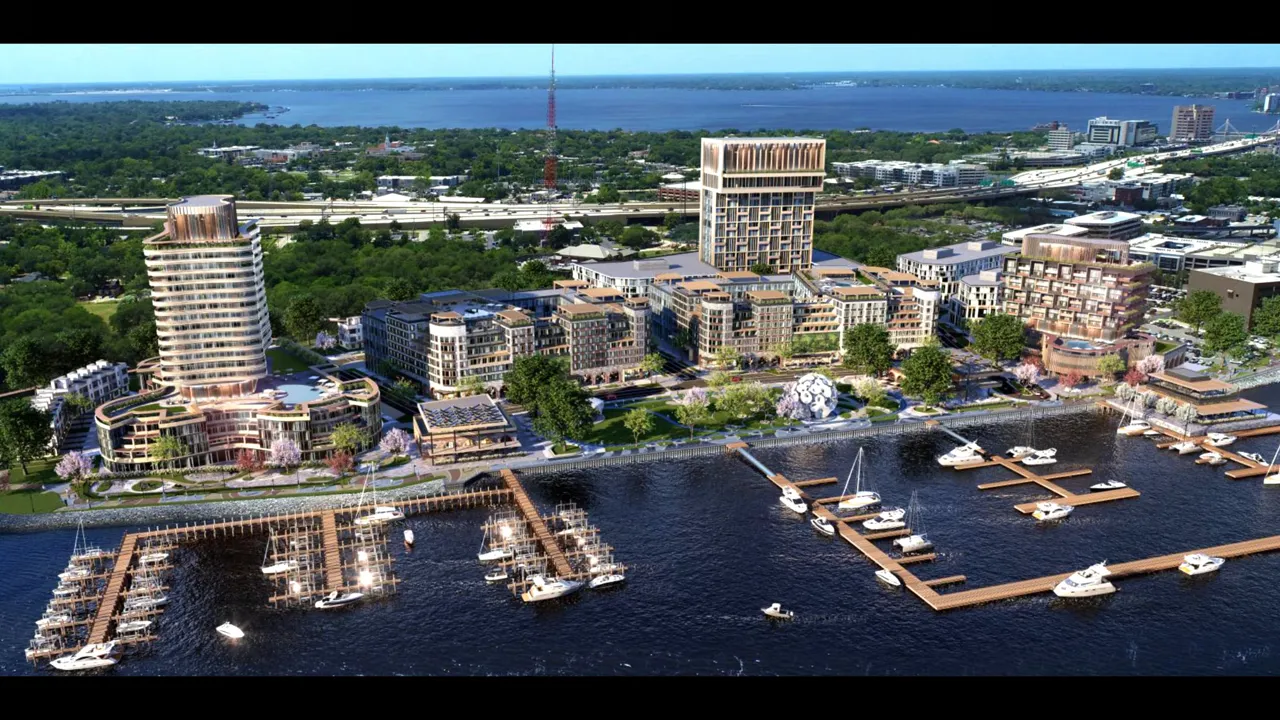 Aerial view rendering of waterfront development with marina docks and boats