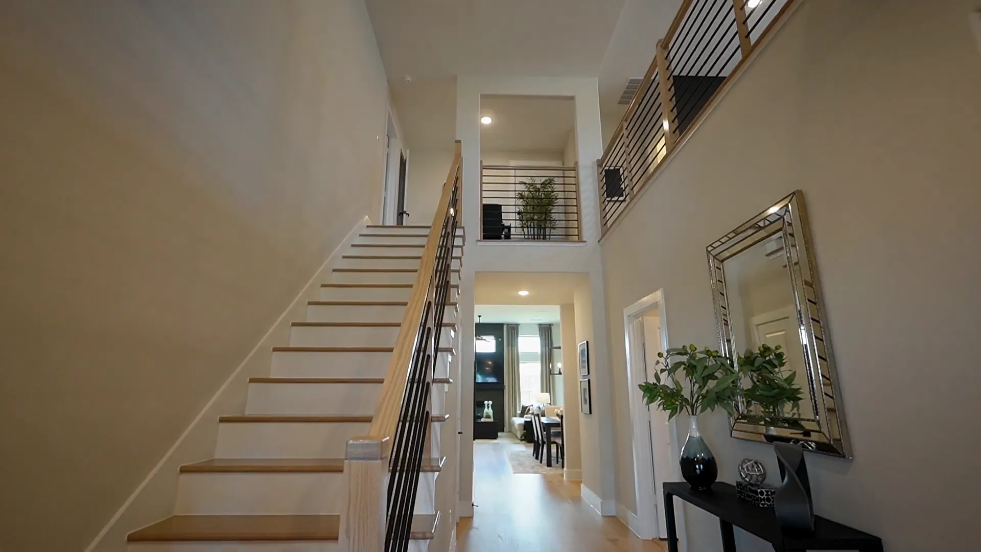 Two-story vaulted ceilings and hardwood floors in the entrance foyer