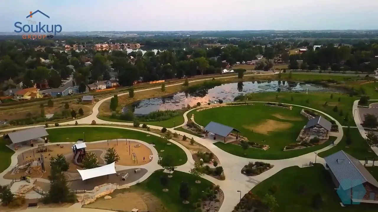 Aerial view of a landscaped park with paths, playgrounds and ponds in Loveland
