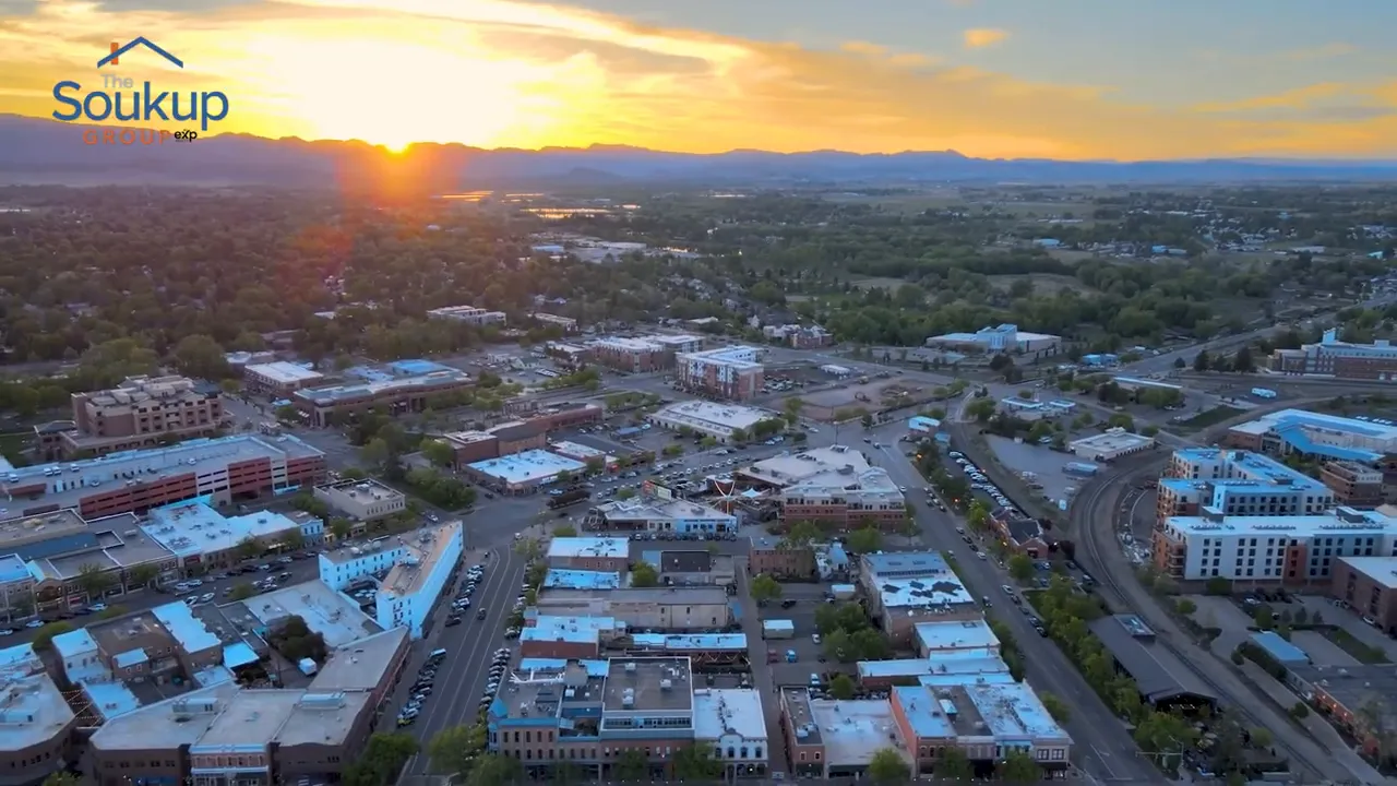 Aerial view of a newer neighborhood at sunset with mountains in the distance