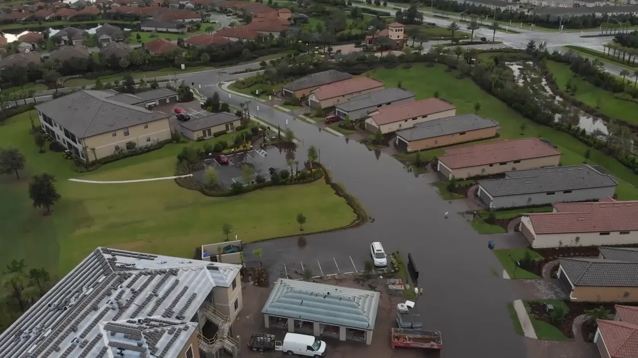 aerial view of neighborhood streets and yards filled with floodwater